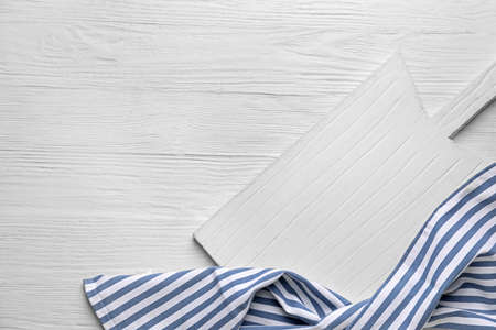 Clean napkin with cutting board on wooden backgroundの写真素材