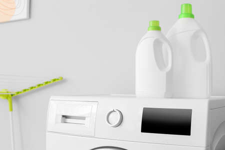 Modern washing machine and detergents in bathroomの写真素材