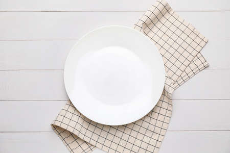 Clean napkin with plate on wooden backgroundの写真素材