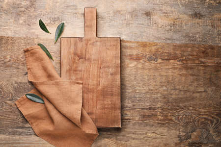 Clean napkin with cutting board on wooden backgroundの写真素材