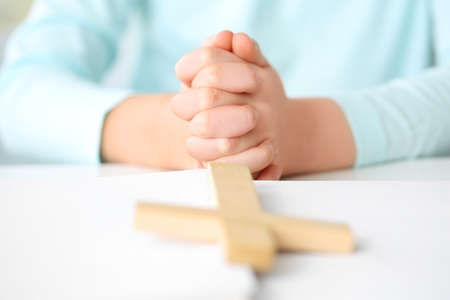 Cute little girl praying at home, closeupの写真素材