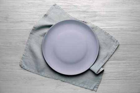 Clean napkin with plate on wooden backgroundの写真素材
