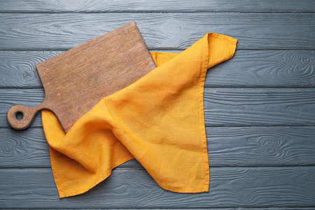 Clean napkin with cutting board on wooden backgroundの写真素材