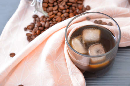 Glass of tasty iced coffee on table