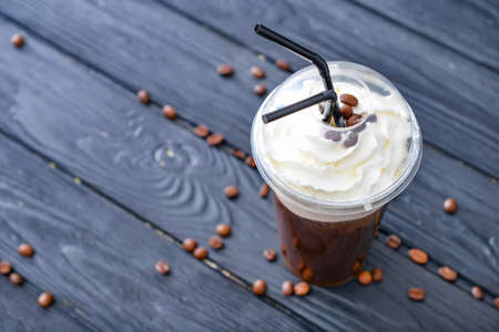 Cup of tasty iced coffee on tableの写真素材