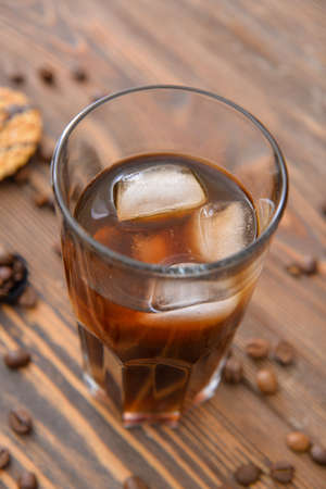 Glass of tasty iced coffee on table