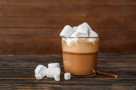 Glass of hot chocolate with marshmallows on wooden backgroundの写真素材