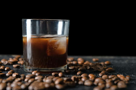 Glass of tasty iced coffee on dark backgroundの写真素材