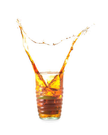 Glass of tasty cold ice tea with splash on white backgroundの写真素材