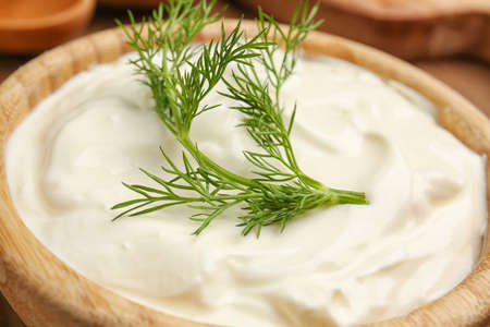 Bowl with tasty sour cream on table, closeupの写真素材