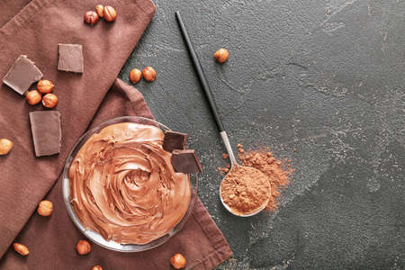 Bowl with tasty chocolate paste and hazelnuts on dark backgroundの写真素材
