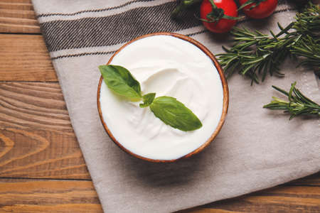 Bowl with tasty sour cream on tableの写真素材
