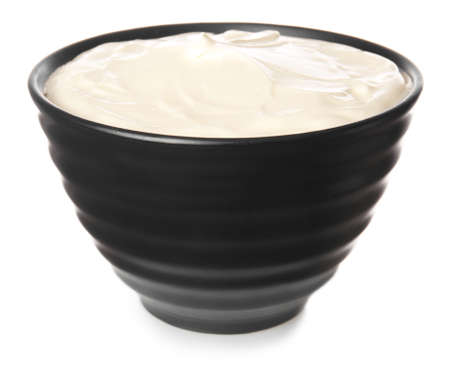 Bowl with tasty sour cream on white backgroundの写真素材
