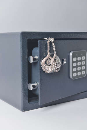 Safe box with valuables on light backgroundの写真素材