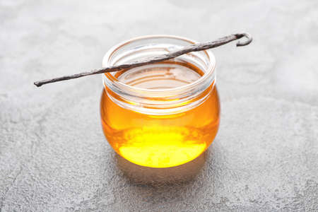 Jar with vanilla extract on gray backgroundの写真素材