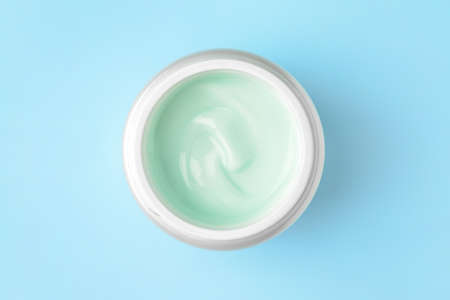 Jar of cosmetic cream on color backgroundの写真素材