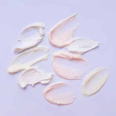 Samples of cosmetic cream on color backgroundの写真素材