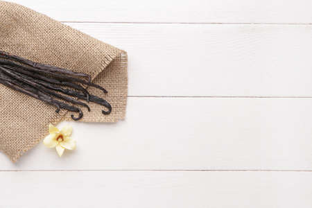 Aromatic vanilla sticks on white wooden background
