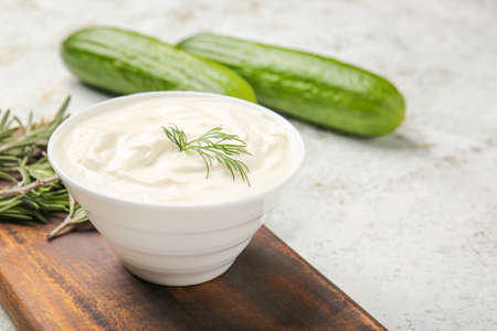 Bowl with tasty sour cream on tableの写真素材