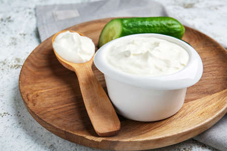 Bowl with tasty sour cream on tableの写真素材