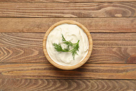Bowl with tasty sour cream on tableの写真素材