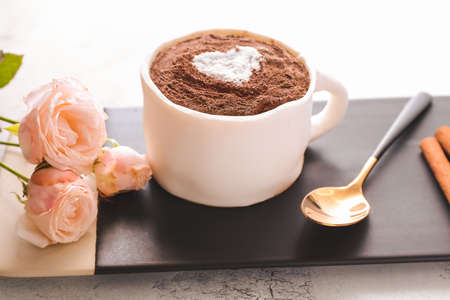Chocolate cake in shape of coffee cup on boardの写真素材