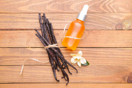 Aromatic vanilla extract on wooden backgroundの写真素材