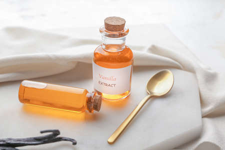 Bottles with aromatic vanilla extract on tableの写真素材