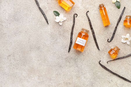Composition with aromatic vanilla sticks and extract on light backgroundの写真素材