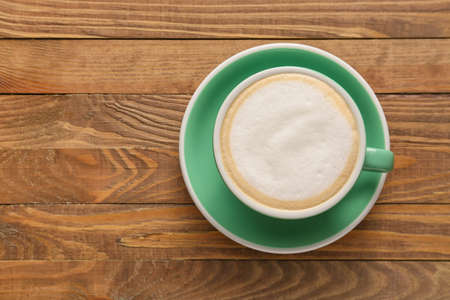 Cup of hot coffee on wooden tableの写真素材