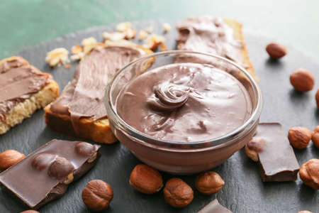 Fresh bread and chocolate paste on slate plate, closeupの写真素材