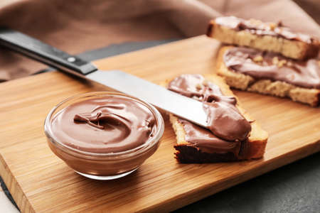Fresh bread and chocolate paste on board, closeupの写真素材