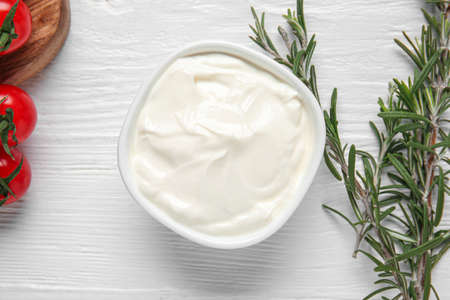 Bowl of tasty sour cream on wooden tableの写真素材