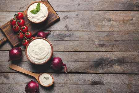 Composition with tasty sour cream on tableの写真素材