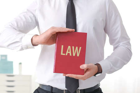 Male lawyer with book in officeの写真素材
