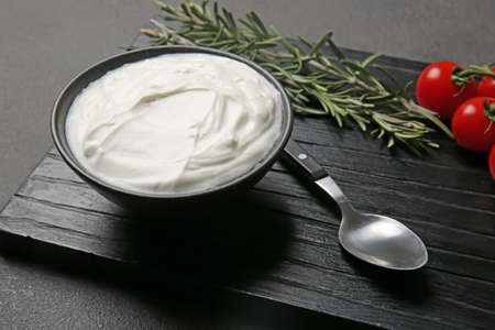 Bowl of tasty sour cream on tableの写真素材