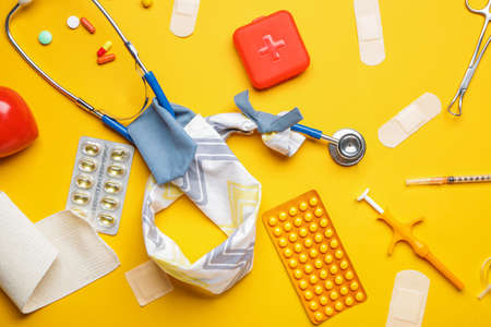 Stethoscope with cover and supplies on color backgroundの写真素材