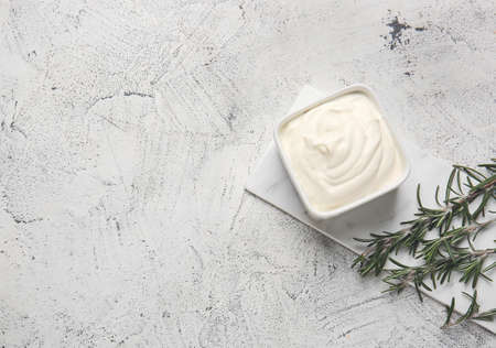 Bowl of tasty sour cream on tableの写真素材