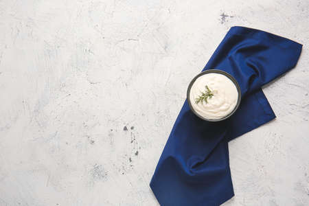 Bowl of tasty sour cream on light tableの写真素材