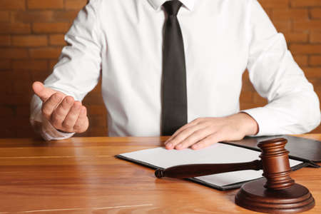 Male judge at table in courtroom, closeup