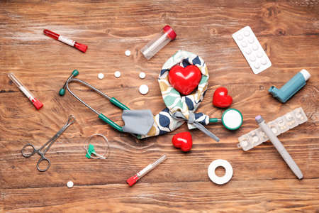 Stethoscope with cover, hearts and supplies on wooden backgroundの写真素材