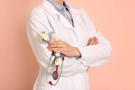 Female doctor with stethoscope on color background, closeupの写真素材