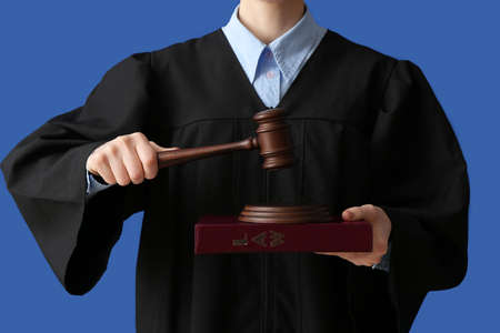 Female judge with gavel on color backgroundの写真素材