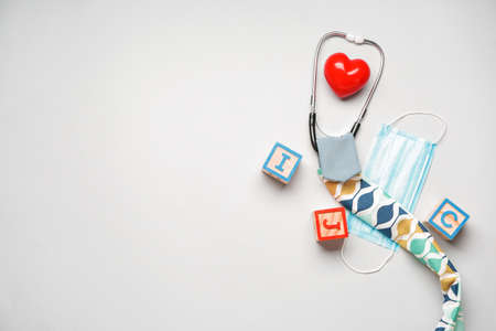 Stethoscope with cover, protective mask and cubes on white backgroundの写真素材