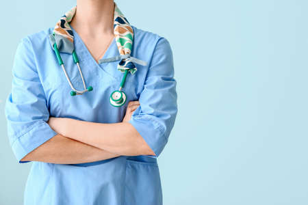 Female doctor with stethoscope on color background, closeupの写真素材