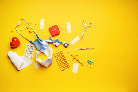 Stethoscope with cover, heart and supplies on color backgroundの写真素材