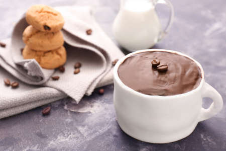 Chocolate cake in shape of coffee cup on dark backgroundの写真素材