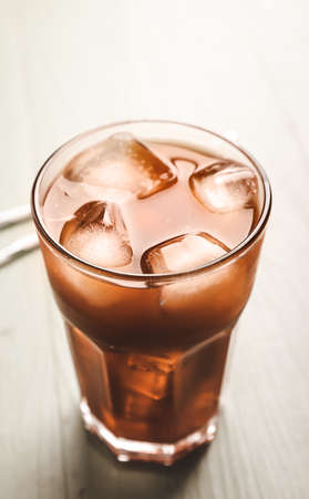 Glass of tasty iced coffee on tableの写真素材
