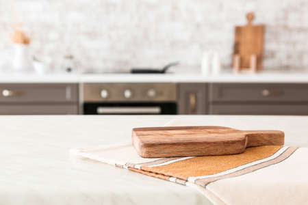 Cutting board and napkin on kitchen tableの写真素材