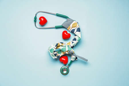 Stethoscope with cover and hearts on color backgroundの写真素材